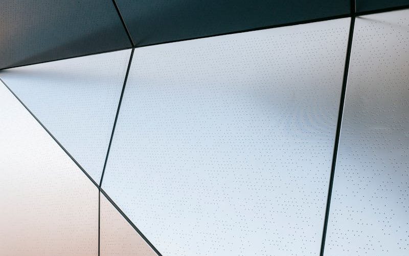 Full frame of abstract geometric background of steel wall with straight lines and angles